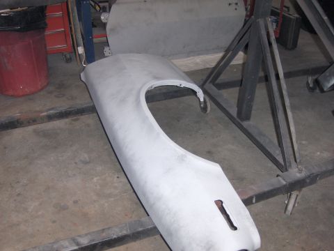 1972 Chevrolet Camaro - A car fender and door are prepped for repair in a workshop setting.