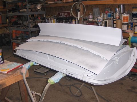 1972 Chevrolet Camaro - Automotive body panels, likely a car door and hood, are shown in a workshop setting, ready for painting.