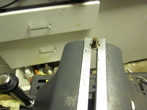 1979 Ford Bronco - A vise grips a bolt, with drawers and various items visible in the background.