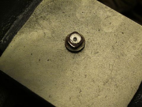 1979 Ford Bronco - A single bolt with a washer is visible on a textured surface, with a watermark at the bottom right.