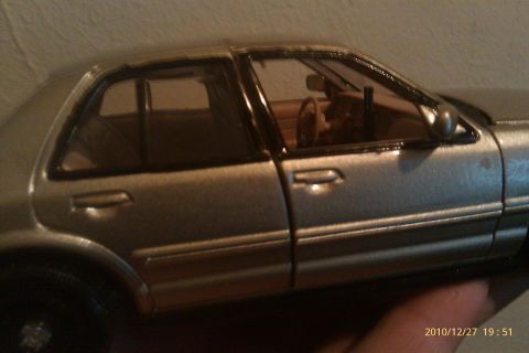 2000 Mercury Grand Marquis - A silver sedan model is shown from the side, with a visible interior and steering wheel.