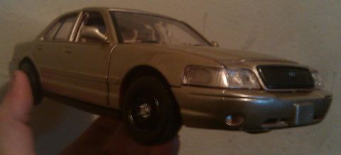 2000 Mercury Grand Marquis - This gold model appears to be a 2000 Mercury Grand Marquis, viewed from the front three-quarter angle.