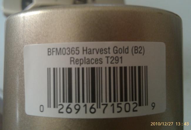 Close-up of a gold-colored part with a white label showing a barcode and text: BFM0365 Harvest Gold (B2) Replaces T291