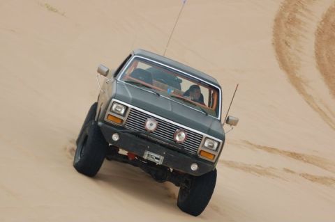1982 Ford Bronco - Ford Bronco navigates a sandy incline, its off-road capabilities.