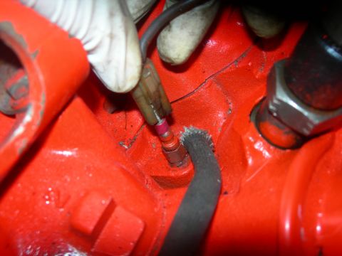 1984 Ford Bronco - Engine component detail, possibly a sensor or switch, with wiring attached.