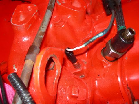 1984 Ford Bronco - Engine component with electrical connections, likely a sensor on an engine block.