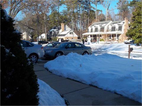 1972 Ford Ranchero - A residential street scene with several cars partially buried in snow after a winter storm.