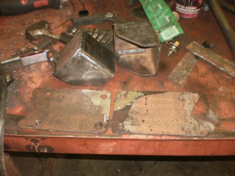 1995 Ford Bronco - Metal fabrication parts and tools are laid out on a workbench.