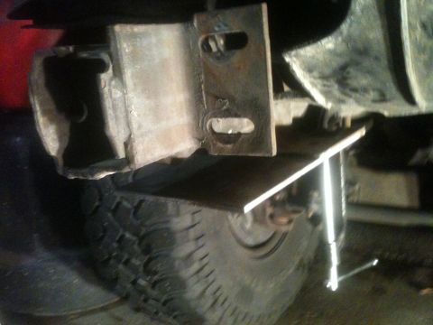 1996 Ford Bronco - Custom trailer hitch receiver installation in progress, with a tire visible below the mounting hardware.