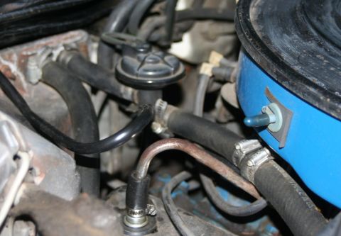 1976 Ford Ranchero - Engine bay vacuum hoses and a blue air cleaner housing are visible in this close-up shot.
