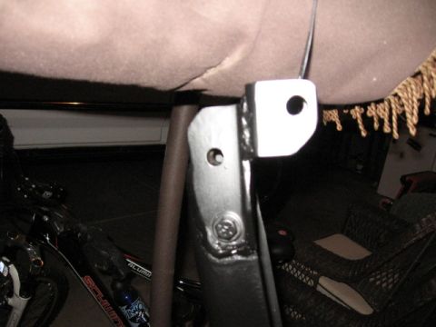1995 Ford Bronco - Close-up of a metal bracket with visible hardware and mounting points.