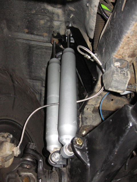 1995 Ford Bronco - Close-up view of dual front shock absorbers and their mounting hardware.
