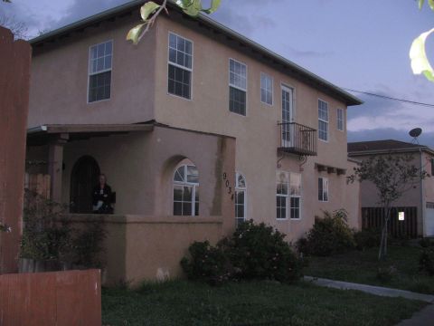 1968 Ford Mustang - Exterior view of a two-story house with a balcony and visible address number 9034.