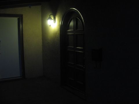 1968 Ford Mustang - A dark scene shows an arched doorway next to a lit wall sconce.