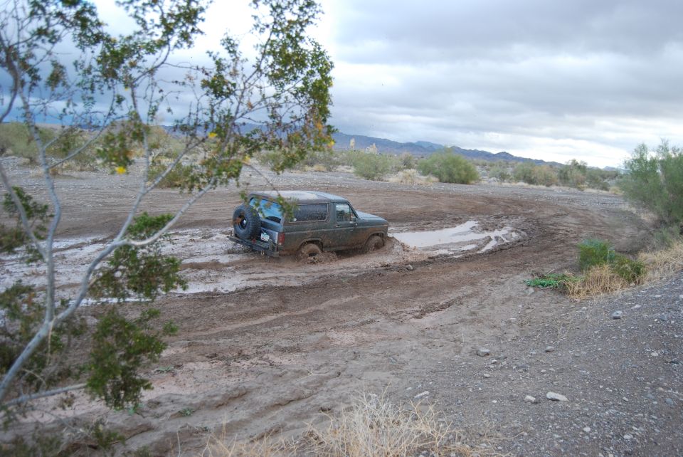 1982 Ford Bronco stuck in mud on a trail