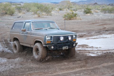 1982 Ford Bronco - This 1980 Ford Bronco navigates a muddy off-road course, kicking up water and dirt.