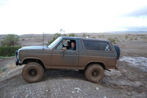 1982 Ford Bronco - This 1982 Ford Bronco is shown off-roading in a muddy, arid landscape.