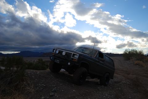 1982 Ford Bronco - This 1982 Ford Bronco navigates an off-road trail under a dramatic sky.
