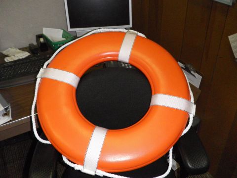 1991 Ford Bronco - An orange life preserver is placed on a chair in an office setting, with a computer and desk visible in the background.