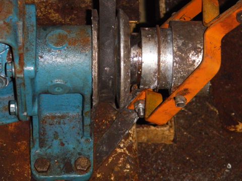 1991 Ford Bronco - A close-up view of a belt and pulley system, likely part of machinery, with visible rust and wear.