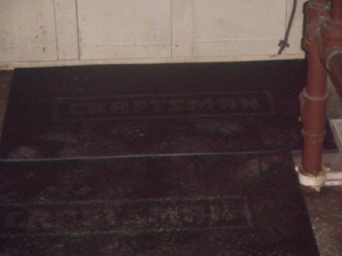 1991 Ford Bronco - Two black Craftsman floor mats are shown on the floor next to a red pipe.