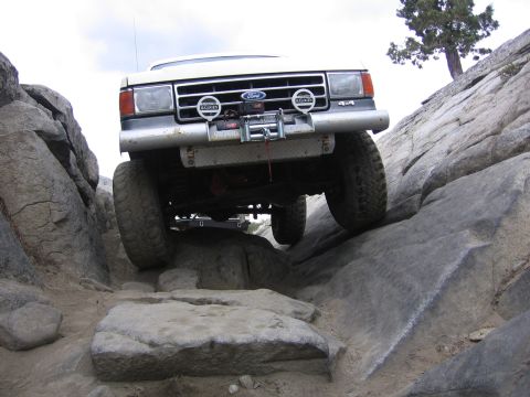 1991 Ford Bronco - This Ford Bronco is navigating a challenging rocky terrain, demonstrating its off-road capabilities.