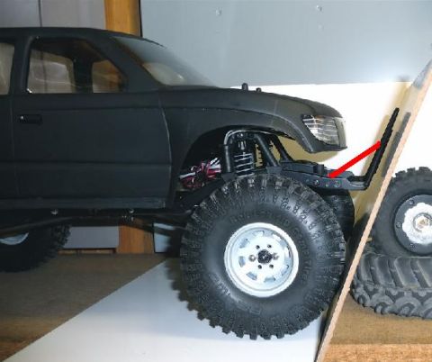 1996 Ford Bronco - Close-up of a remote control truck's front wheel and fender assembly.