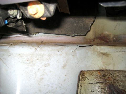 1996 Ford Bronco - Detail of corrosion and hardware on what appears to be undercarriage metal.