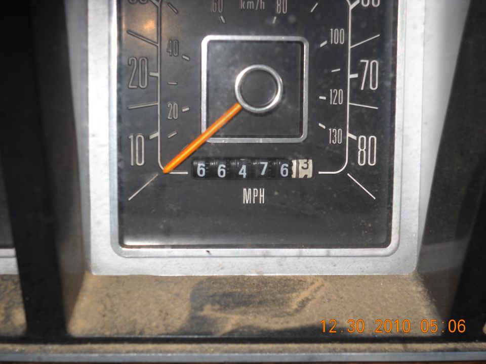 Close-up of a vehicle's odometer showing 66476 miles. Speedometer has markings up to 80 MPH
