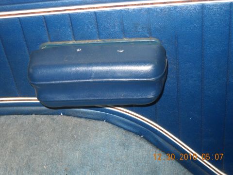 1982 Ford Bronco - Close-up of a blue interior door panel and armrest, with a timestamp in the corner.