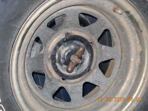 1982 Ford Bronco - Close-up of a wheel hub and tire, showing the center cap and lug nuts.