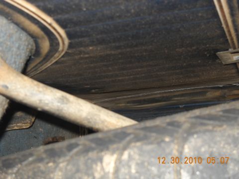 1982 Ford Bronco - Close-up of the undercarriage, focusing on suspension parts and a tire, with a date stamp visible.