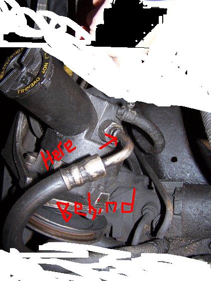 1995 Ford Bronco - Close-up view of a power steering pump, with red markings highlighting specific areas.