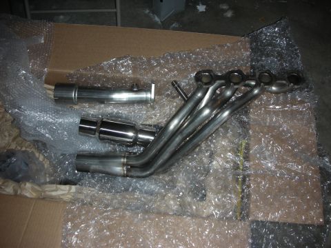 2004 Ford Crown Victoria - New exhaust headers and catback system parts are unboxed and ready for installation.