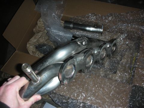 2004 Ford Crown Victoria - New exhaust headers are shown inside their packaging, ready for installation.