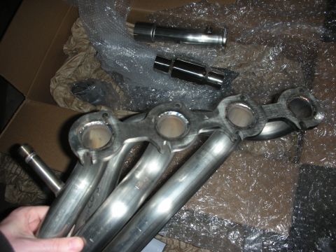 2004 Ford Crown Victoria - Close-up of new exhaust headers and pipes, likely for an aftermarket upgrade.