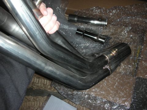 2004 Ford Crown Victoria - New stainless steel exhaust headers and catback system components are shown, ready for installation.