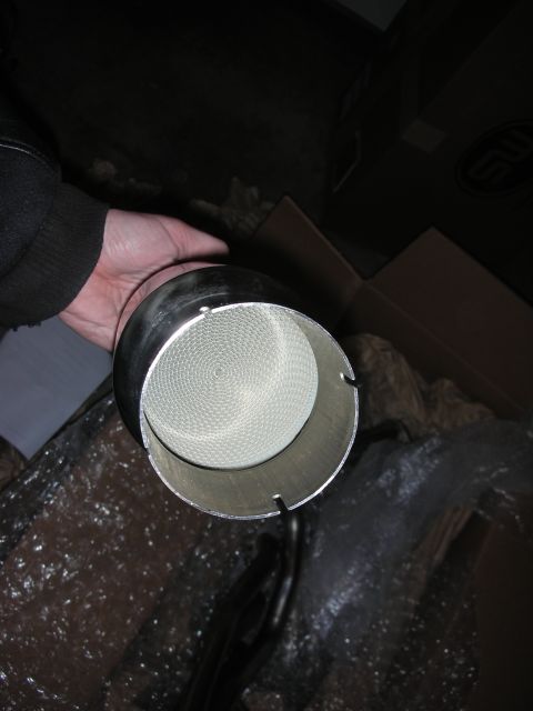 2004 Ford Crown Victoria - Close-up of a catalytic converter, showing its internal honeycomb structure.