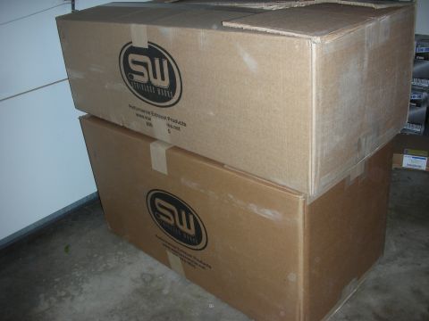 2004 Ford Crown Victoria - Cardboard boxes labeled "SW Stainless Works" and "Performance Exhaust Products" are stacked indoors.
