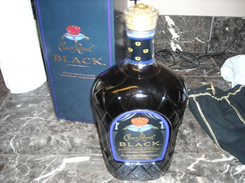 1979 Ford F-150 - A bottle of Crown Royal Black whisky and its accompanying box are displayed on a marble countertop.