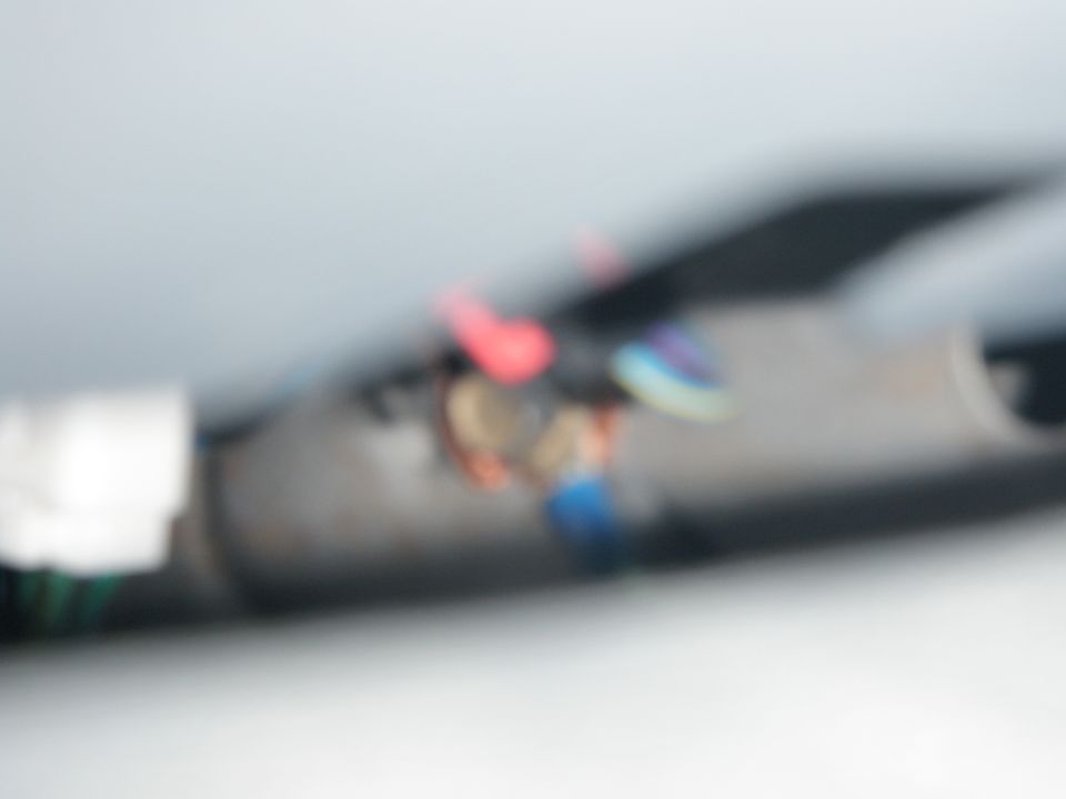 Wires and connectors with red, blue, and purple insulation, some exposed copper