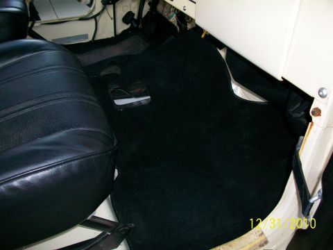 1986 Jeep Wagoneer - Interior view showing black carpet and a black leather seat, with a date stamp of 12/31/2010.