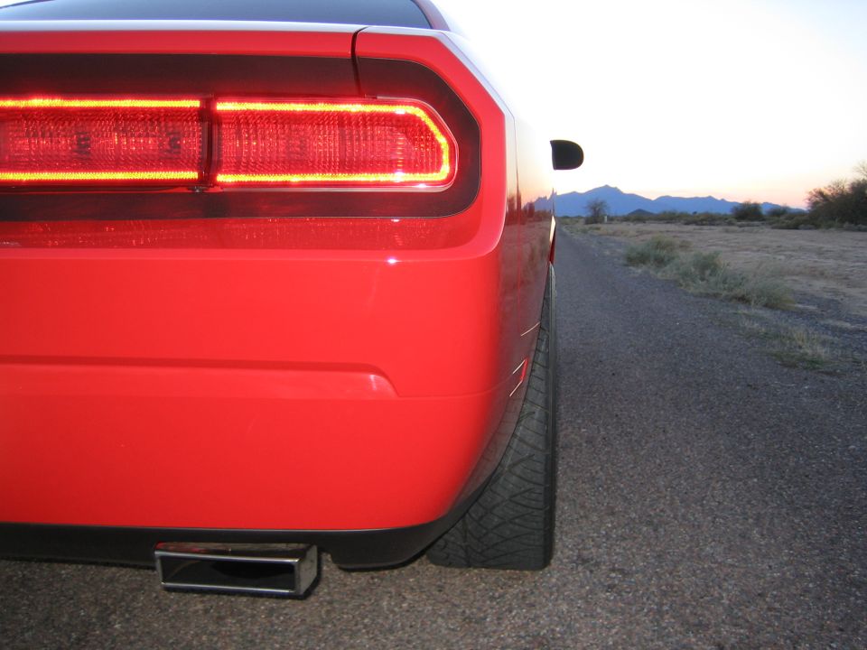 Red 2010 Dodge Challenger rear quarter view with LED taillights and square exhaust tip