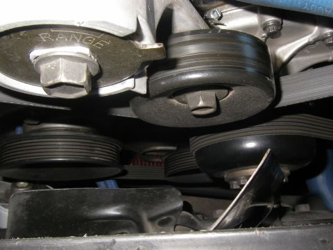 1990 Ford Bronco - Engine bay detail showing belt tensioner and pulleys, with visible text 'RANGE'.