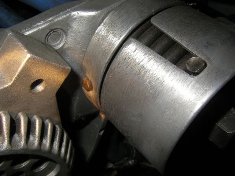 1990 Ford Bronco - Detail of a mechanical fan belt tensioner assembly, showing gears and internal springs.