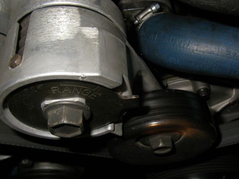 1990 Ford Bronco - Engine belt tensioner assembly with visible 'RANGE' marking and a blue hose.