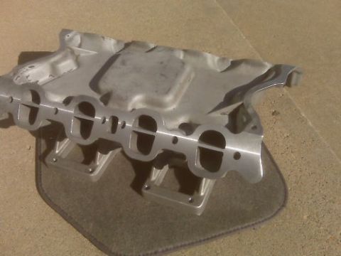 1972 Ford Ranchero - Aluminum intake manifold with dual ports shown on a mat.