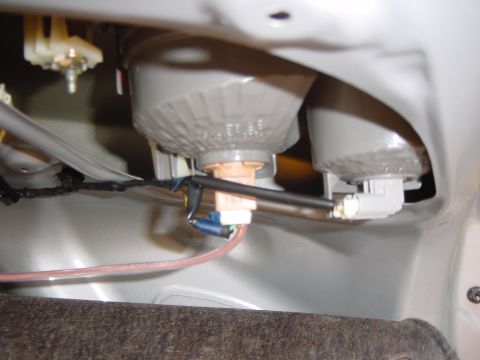 2003 Mazda 6 - Close-up view of the wiring and bulb socket for a vehicle's tail light assembly.