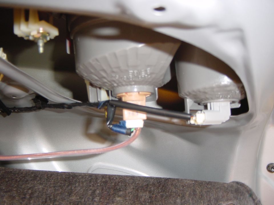 Rear taillight bulb sockets and wiring harness behind the light housing