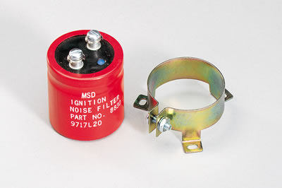 1990 Ford Bronco - A red MSD ignition noise filter and its yellow metal mounting bracket are shown against a white background.